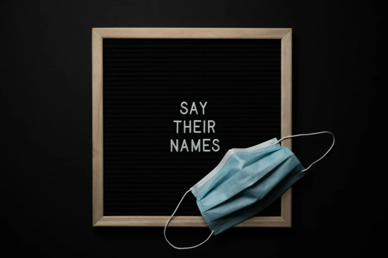 a sign that says say their names with a mask on it, by Carey Morris, shutterstock, 1 6 x 1 6, blackboard, alessio albi, medical mask