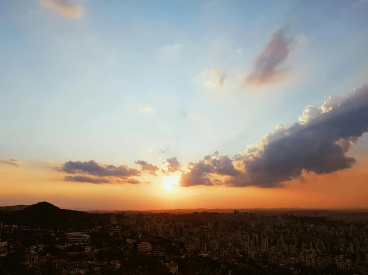 a view of the sun setting over a city, pexels contest winner, colombia, panorama view of the sky, alessio albi, sunny day time