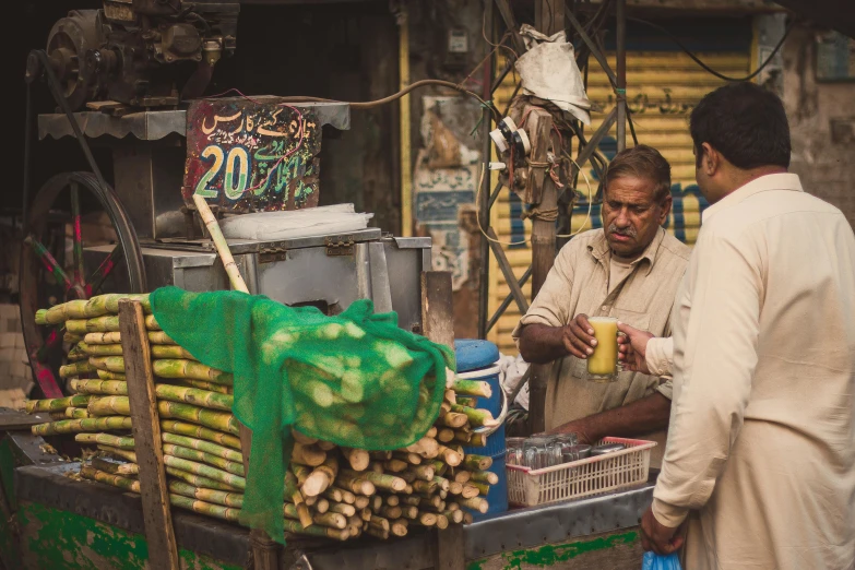 a couple of men standing in front of a food stand, pexels contest winner, kyza saleem, thumbnail, bustling city, green alleys