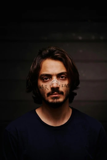 a man with a tattoo on his face, a character portrait, by artist, pexels contest winner, antipodeans, avan jogia angel, mugshot, promotional image, surikov