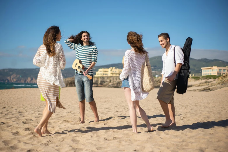 a group of people standing on top of a sandy beach, smiling and dancing, nazare (portugal), profile image, fan favorite