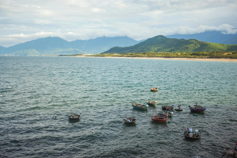 a group of boats floating on top of a body of water, by Daniel Lieske, pexels contest winner, vietnam, avatar image, on the coast, thumbnail