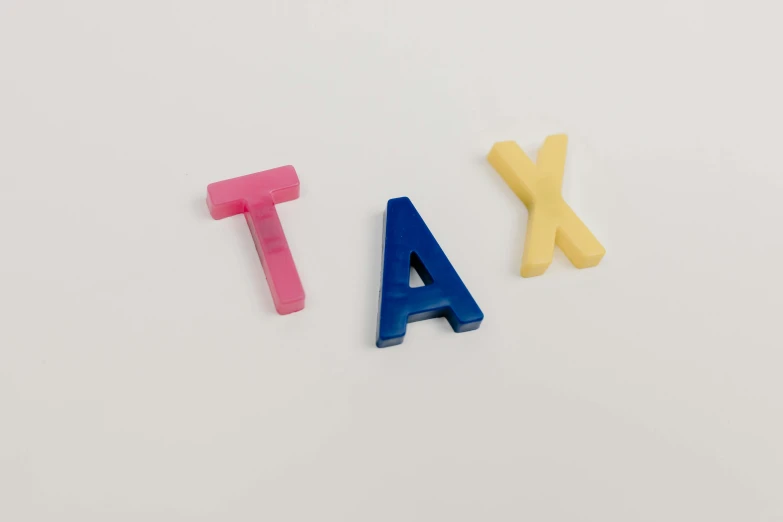 the word tax spelled in plastic letters on a white surface, a cartoon, by Adam Rex, pexels, large pastel, 3 - piece, y, letter a