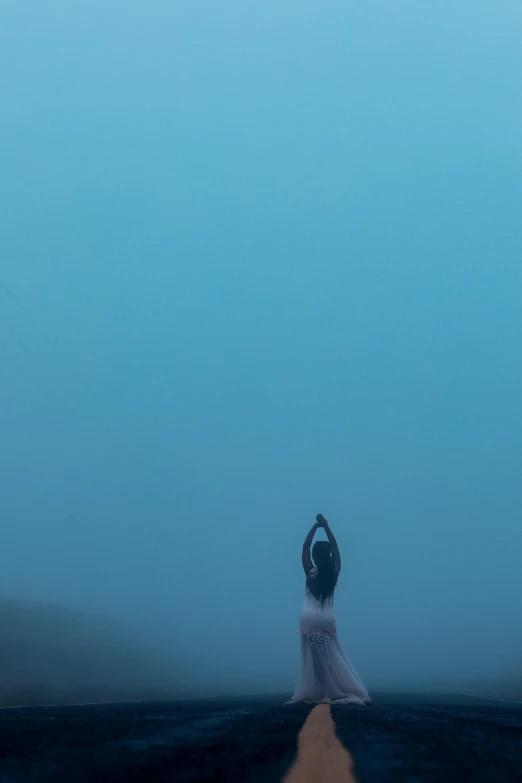 a woman in a white dress standing in the middle of a road, inspired by Brooke Shaden, pexels contest winner, conceptual art, blue - turquoise fog in the void, panoramic view of girl, seen from below, hyperminimalist