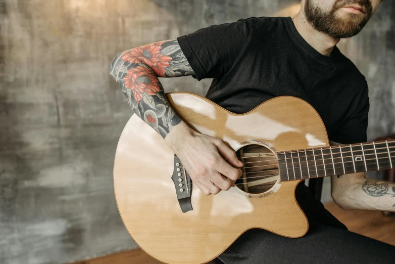 a man with a beard playing a guitar, a tattoo, trending on pexels, photograph of a sleeve tattoo, thumbnail, lachlan bailey, no - text no - logo