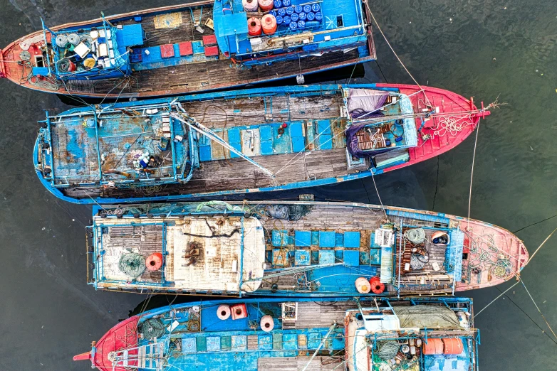 a group of boats sitting on top of a body of water, pexels contest winner, process art, fish seafood markets, large blue engines, flatlay, well worn