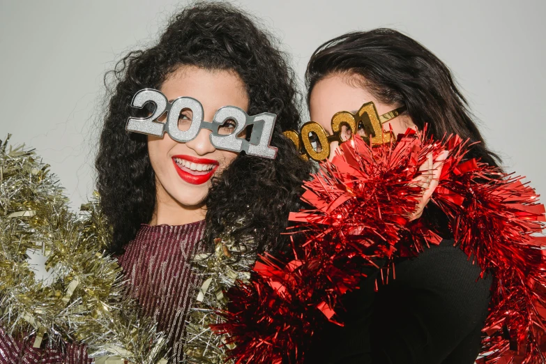 a couple of women standing next to each other, a polaroid photo, trending on pexels, happening, new years eve, silver curly hair, thumbnail, cardboard cutout