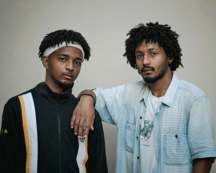 a couple of men standing next to each other, pexels contest winner, black arts movement, dreadlock black hair, wearing correct era clothes, ethiopian, charli bowater and artgeem