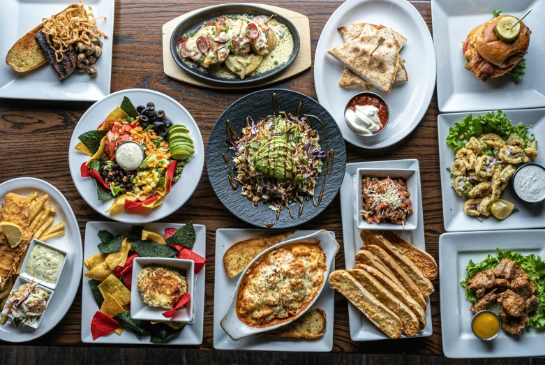 a number of plates of food on a table, rafeal albuquerque, birdseye view, fan favorite, in a medium full shot