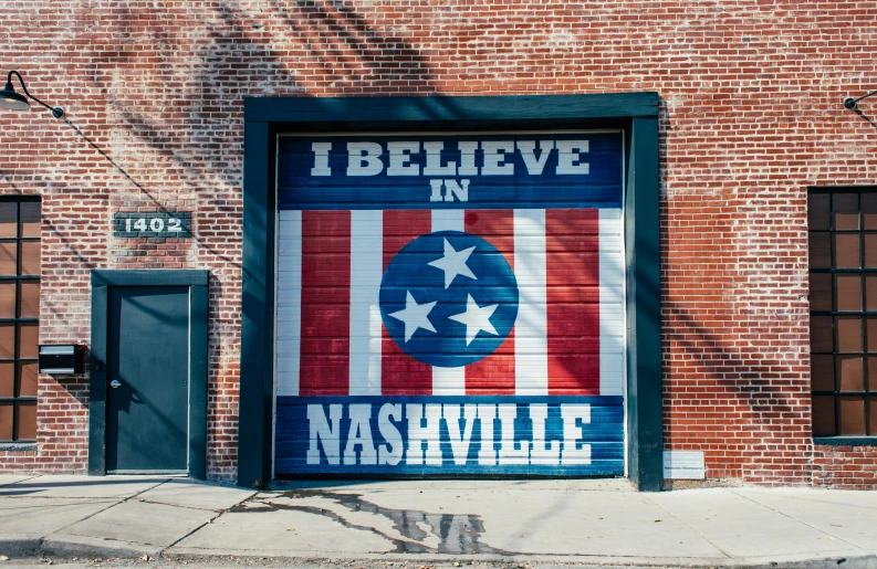 a garage door with the words believe in nashville painted on it, a photo, pexels contest winner, conservative, 1 6 x 1 6, carpool karaoke, american city