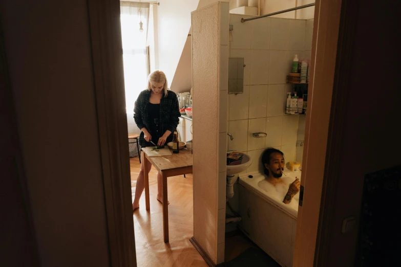 a woman standing next to a child in a bathtub, a photo, by Jan Tengnagel, inside a cozy apartment, profile image, people at the table, documentary photo