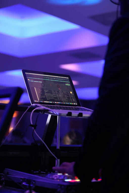 a man standing in front of a laptop computer, an album cover, by Robbie Trevino, unsplash, happening, event, dj mixer, cyber embellishment, dos