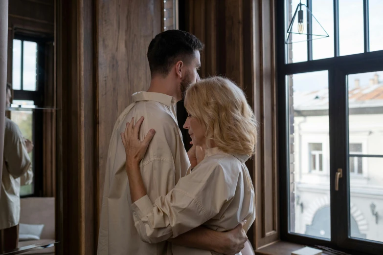 a woman hugging a man in front of a window, pexels contest winner, renaissance, background image, blonde man, intertwined full body view, romantic couple