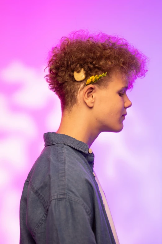 a close up of a person with curly hair, inspired by Antoni Pitxot, undercut, young teen, matt mute colour background, from the side