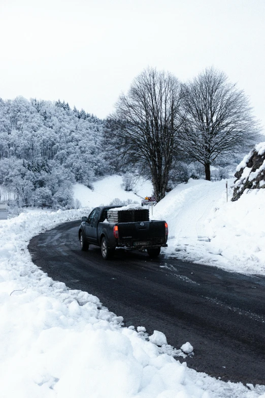 a truck driving down a snow covered road, les nabis, be running up that hill, thumbnail, seasonal, low quality photo