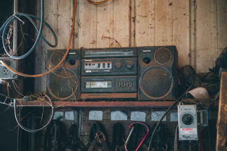 a radio sitting on top of a wooden shelf, trending on pexels, assemblage, scrap metal on workbenches, cassette, inside a shed, music is life