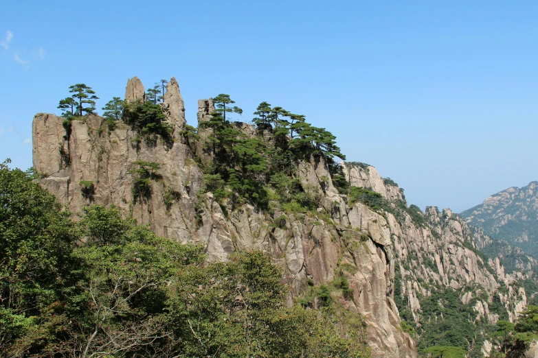 a group of people standing on top of a mountain, mingei, tall stone spires, nature photo, avatar image