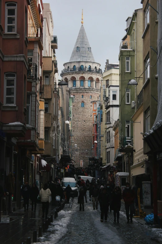 a group of people walking down a street next to tall buildings, a picture, inspired by Niyazi Selimoglu, pexels contest winner, renaissance, neoclassical tower with dome, mixture turkish and russian, staggered terraces, crowded street