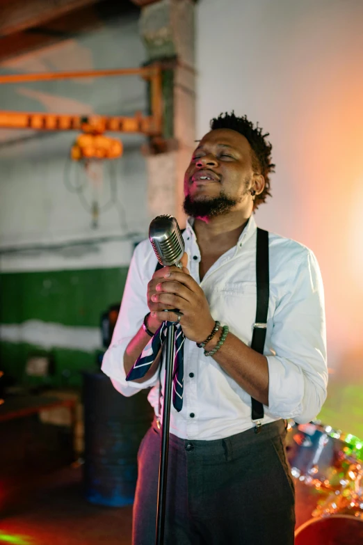 a man that is standing up with a microphone, an album cover, by Chinwe Chukwuogo-Roy, pexels, happening, scruffy man, 15081959 21121991 01012000 4k, worship, in a nightclub