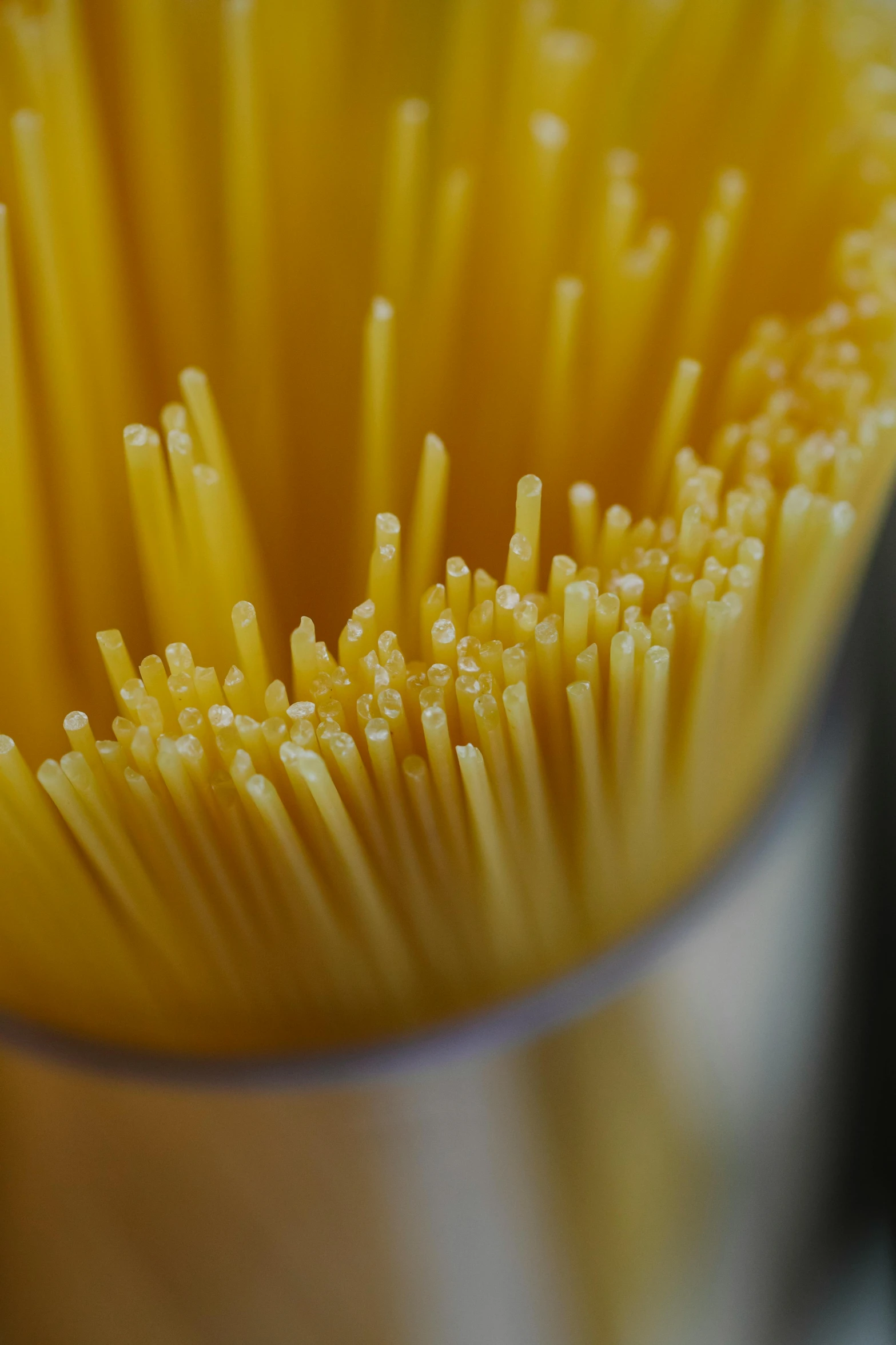 a close up of a bunch of spaghetti noodles, by Matt Cavotta, renaissance, unbeatable quality, inside a glass jar, intricate lining, yellow