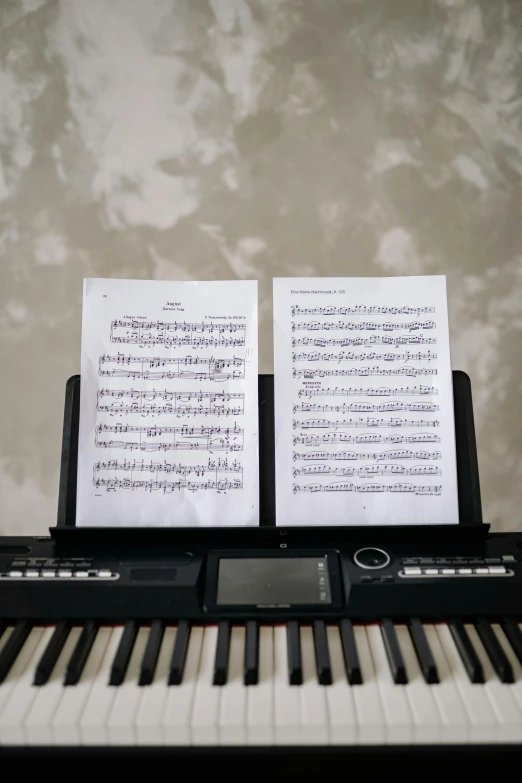 a piano with sheet music sitting on top of it, by Carey Morris, pexels, split in half, everything fits on the screen, tomoyuki yamasaki, wide frontal view