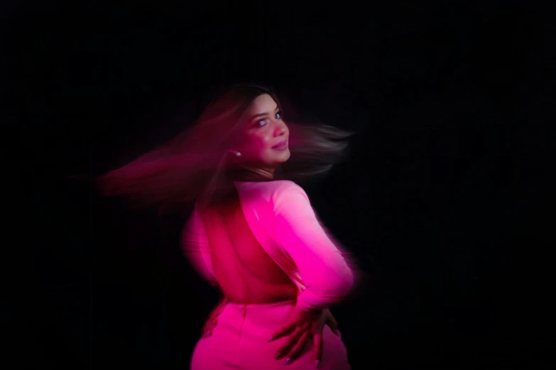 a woman with long hair in a pink dress, an album cover, by Olivia Peguero, pexels contest winner, plus-sized, back lighting, glowing in the dark, taken with sony alpha 9