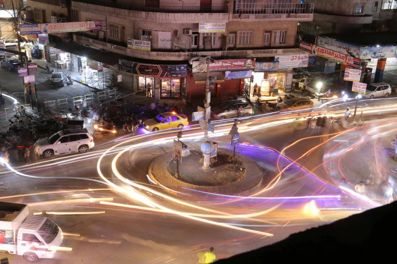 a city street filled with lots of traffic at night, by Ahmed Yacoubi, hurufiyya, spiraling, lightshow, street corner, brown