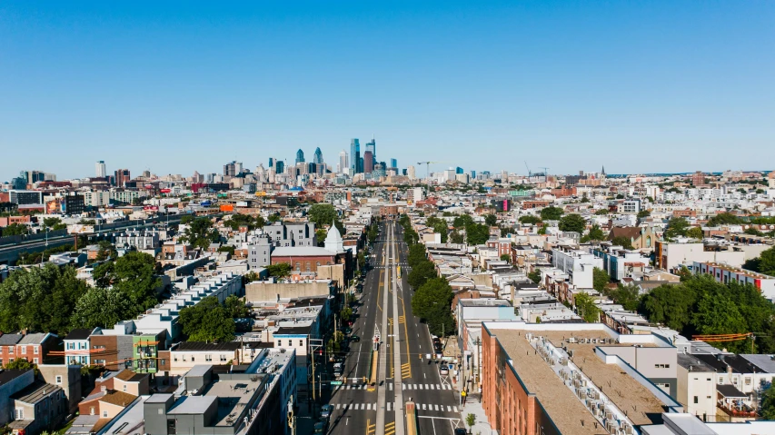 a view of a city from the top of a building, by Carey Morris, pexels contest winner, new jersey, clear skies in the distance, city streetscape, wide aerial shot