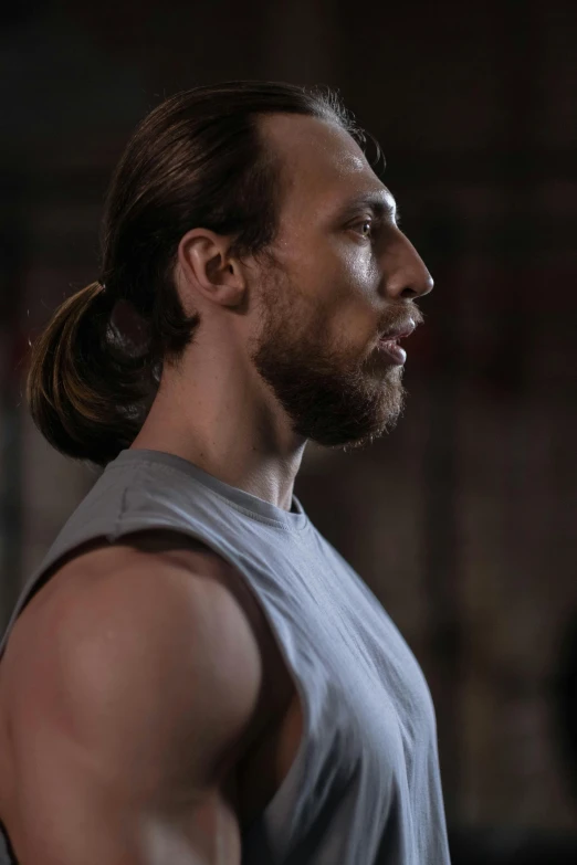 a man with a ponytail in a gym, inspired by James Baynes, trending on pexels, renaissance, mid long hair, shot from movie, no cropping, 30 year old man :: athletic