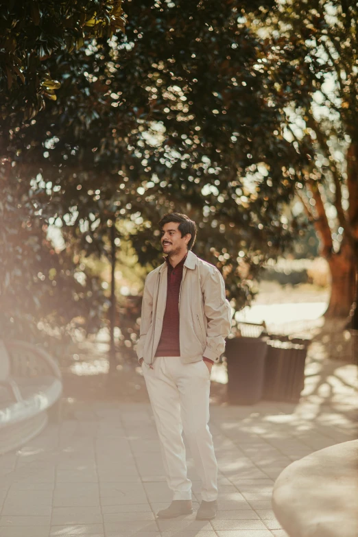 a man riding a skateboard down a sidewalk, a picture, pexels contest winner, light brown trenchcoat, standing in a botanical garden, young spanish man, thoughtful