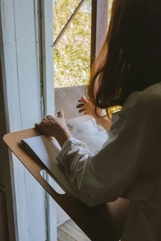 a woman sitting at a desk writing on a piece of paper, a drawing, inspired by Elsa Bleda, pexels contest winner, leaning on door, summer light, carrying a tray, mystery horror