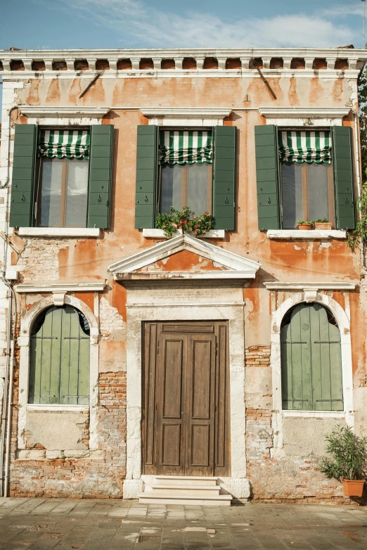 a building with green shutters on a sunny day, inspired by Michelangelo Buonarotti, renaissance, brown, architectural digest, venice, farmhouse