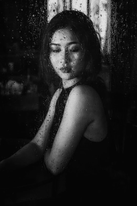 a black and white photo of a woman sitting in front of a window, a black and white photo, pexels contest winner, covered in water drops, asian female, battered, cindy avelino