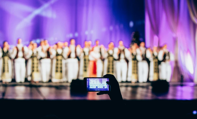 a person taking a picture of a choir, by Julia Pishtar, ukraine. professional photo, on stage, unedited, instagram post