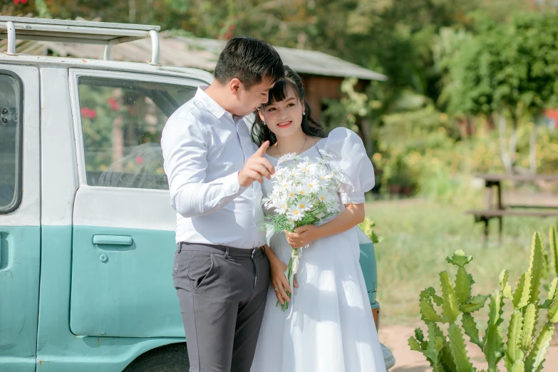 a man and a woman standing next to a van, pexels contest winner, romanticism, wearing a cute white dress, vietnamese woman, 15081959 21121991 01012000 4k, bouquet