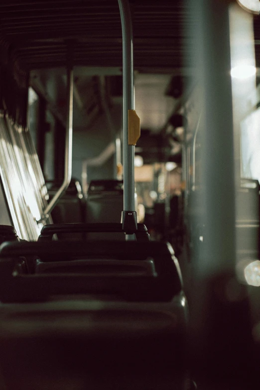 a bus filled with lots of seats sitting next to each other, unsplash, medium format. soft light, blurry footage, early morning, cinestill 800t eastmancolor