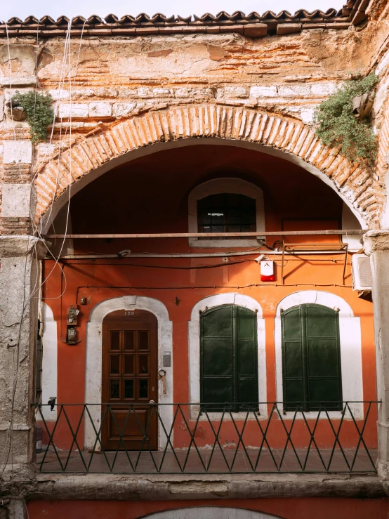 a red and white building with green shutters, a picture, inspired by Marià Fortuny, pexels contest winner, renaissance, orange tones, archway, in a old house. hyper realistic, square