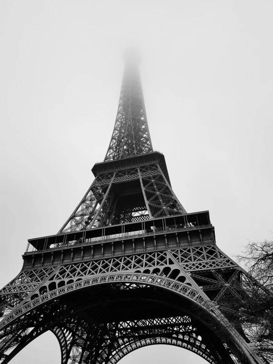 a black and white photo of the eiffel tower, by Adam Rex, fog. by greg rutkowski, various posed, nika maisuradze, famous photo