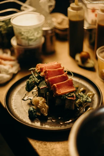 a close up of a plate of food on a table, by Tobias Stimmer, unsplash, raw pork, kyoto inspired, cosy atmosphere, sunken