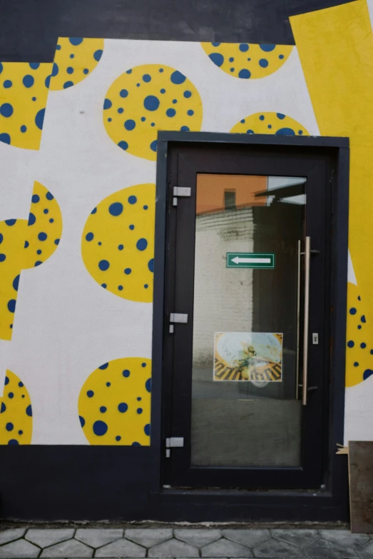 a painting on the side of a building, an album cover, inspired by Patrick Caulfield, unsplash, berlin secession, door, colors: yellow, made of dots, reykjavik junior college