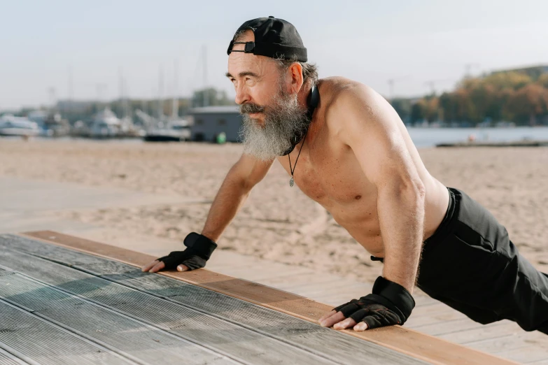 a man doing push ups on a wooden bench, a portrait, by Serhii Vasylkivsky, pexels contest winner, old gigachad with grey beard, at the beach, 30 year old man :: athletic, lachlan bailey