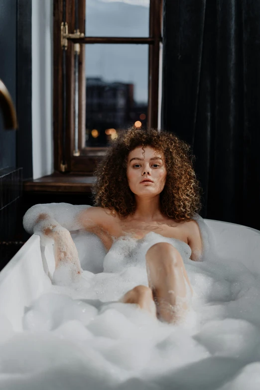 a woman sitting in a bathtub filled with foam, a portrait, trending on pexels, renaissance, curly haired, sexy :8, college, liquified