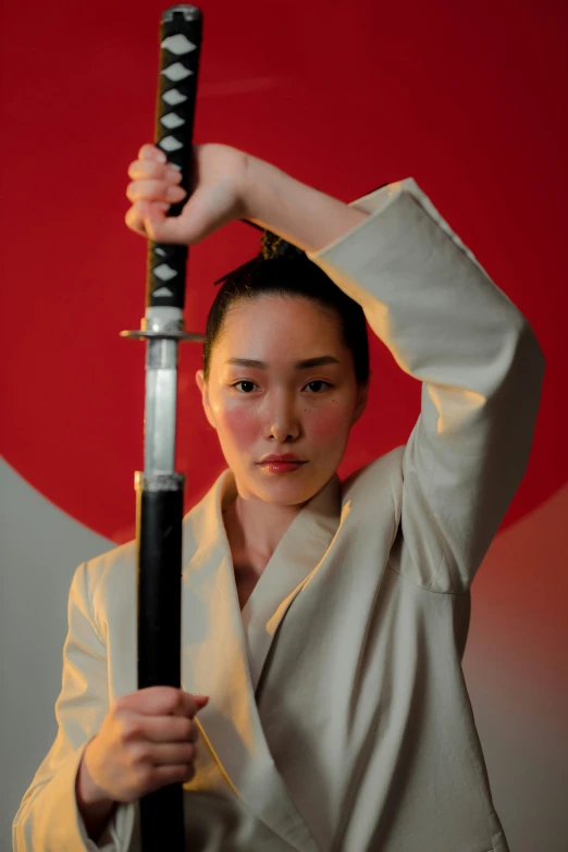 a woman in a kimono is holding a sword, an album cover, unsplash, posing ready for a fight, film still promotional image, headshot, mariko mori