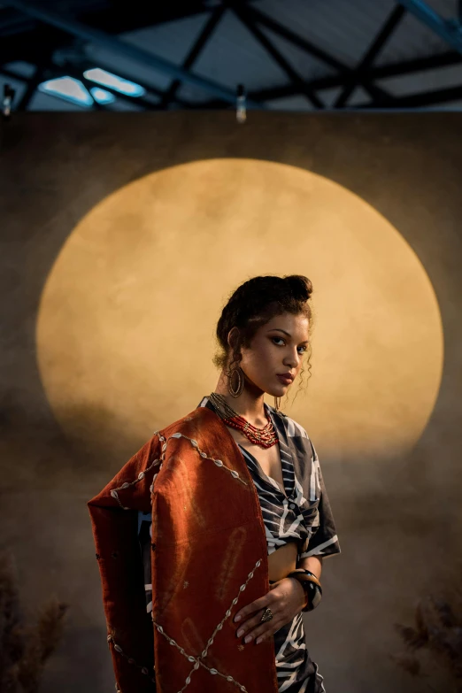 a woman standing in front of a full moon, an album cover, inspired by Lü Ji, unsplash, renaissance, wearing a steampunk sari, portrait of zendaya, geisha photo portrait, low sun