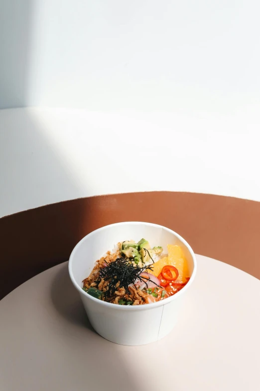 a bowl of food sitting on top of a table, a picture, slightly minimal, indoor picture, item, komorebi