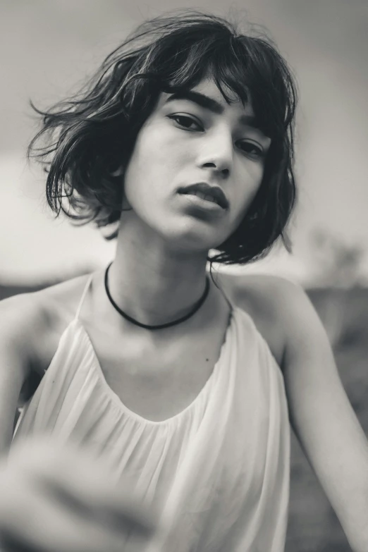 a black and white photo of a woman, by irakli nadar, trending on pexels, wavy and short top hair, wearing choker, young middle eastern woman, medium format. soft light