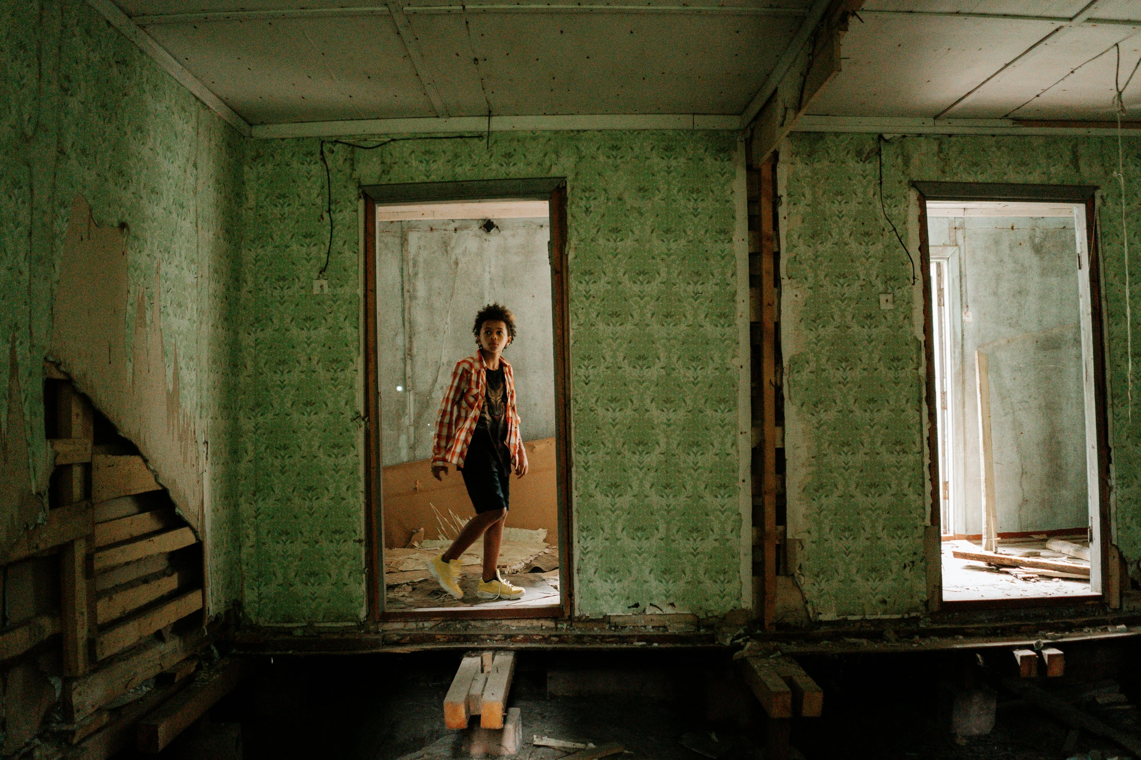 a man that is standing in a room, by Elsa Bleda, pexels contest winner, makeshift house, imaan hammam, teenage girl, in a old house. hyper realistic
