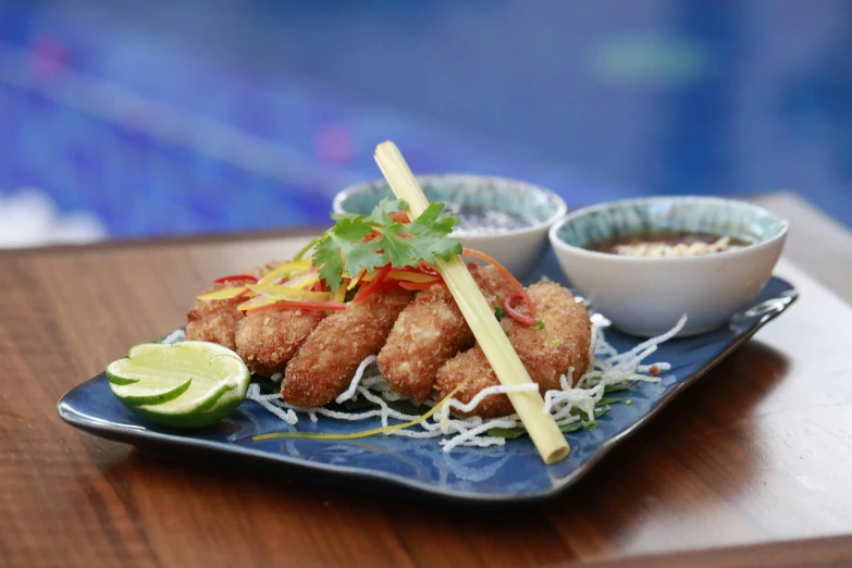 a close up of a plate of food on a table, inspired by Max Buri, poolside, deep fried, fins, bamboo