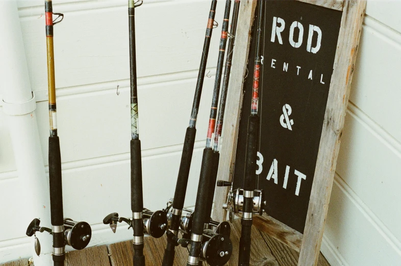 a group of fishing rods sitting on top of a wooden floor, a portrait, unsplash, dau-al-set, 🦩🪐🐞👩🏻🦳, cottage core, black and reddis, rack