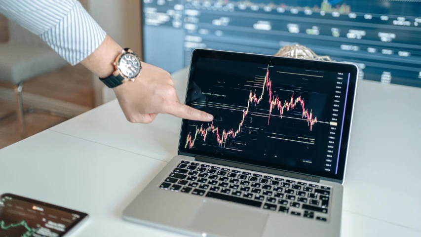 a person pointing to a chart on a laptop, by Adam Marczyński, trending on pexels, analytical art, ripple, mining, very ornate, wētā fx